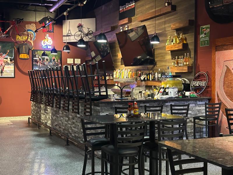 The main bar with taps, stools and cycling memorabilia on the walls.