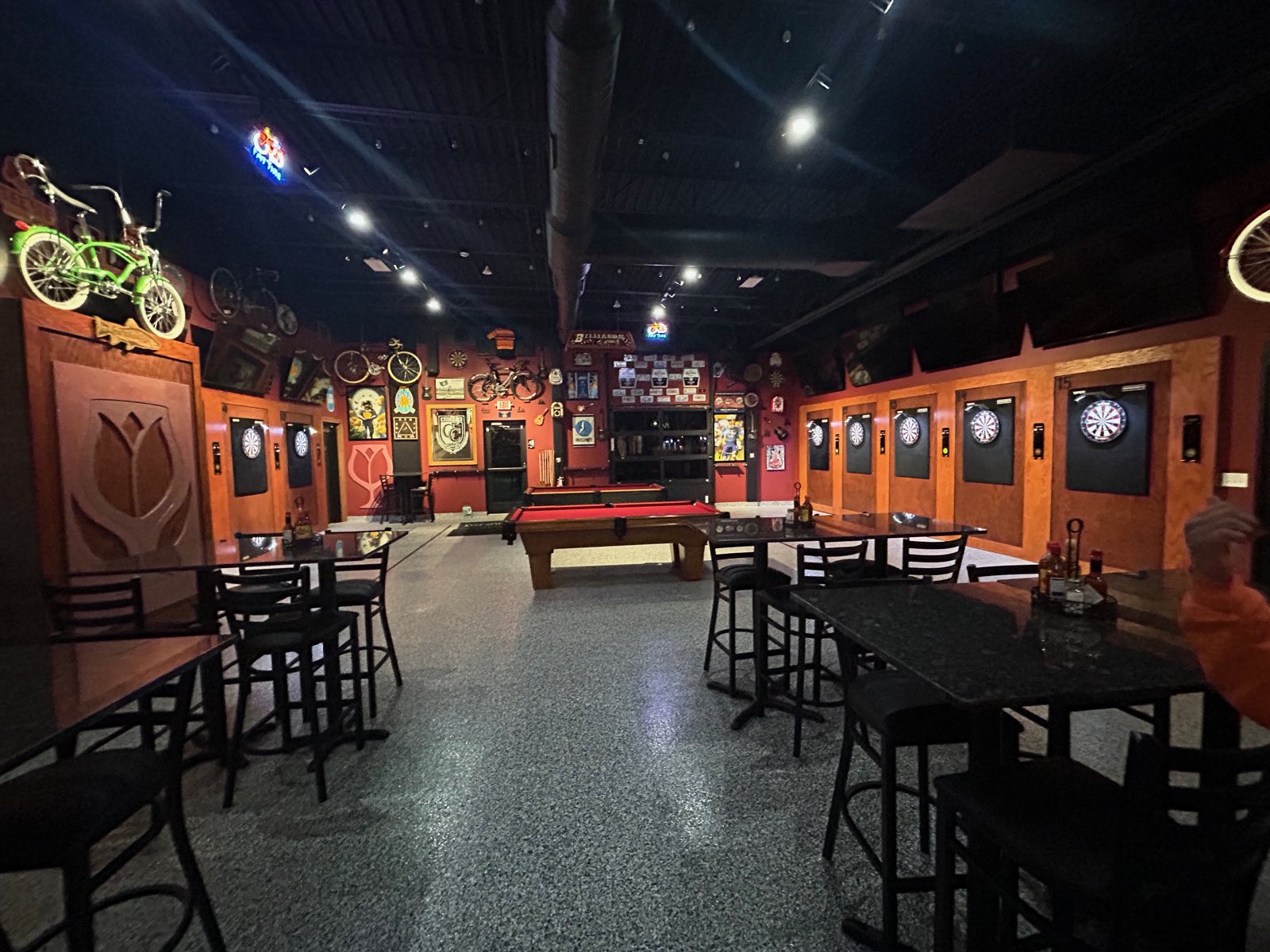 The main game room at Tulip City Bar & Grill, with numbered board bays along the right wall and two pool tables in the centre.