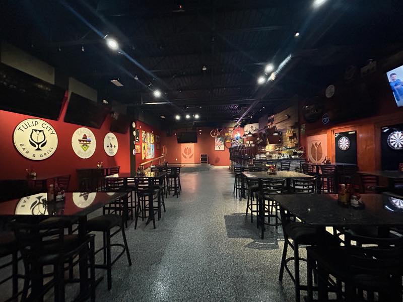 The main dining room with the Tulip City Bar and Grill sign on the red wall.