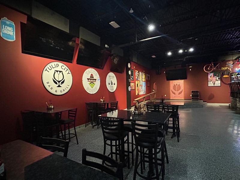 Round signs for Tulip City Bar and Grill, Tacos Borre and Spice Boys.